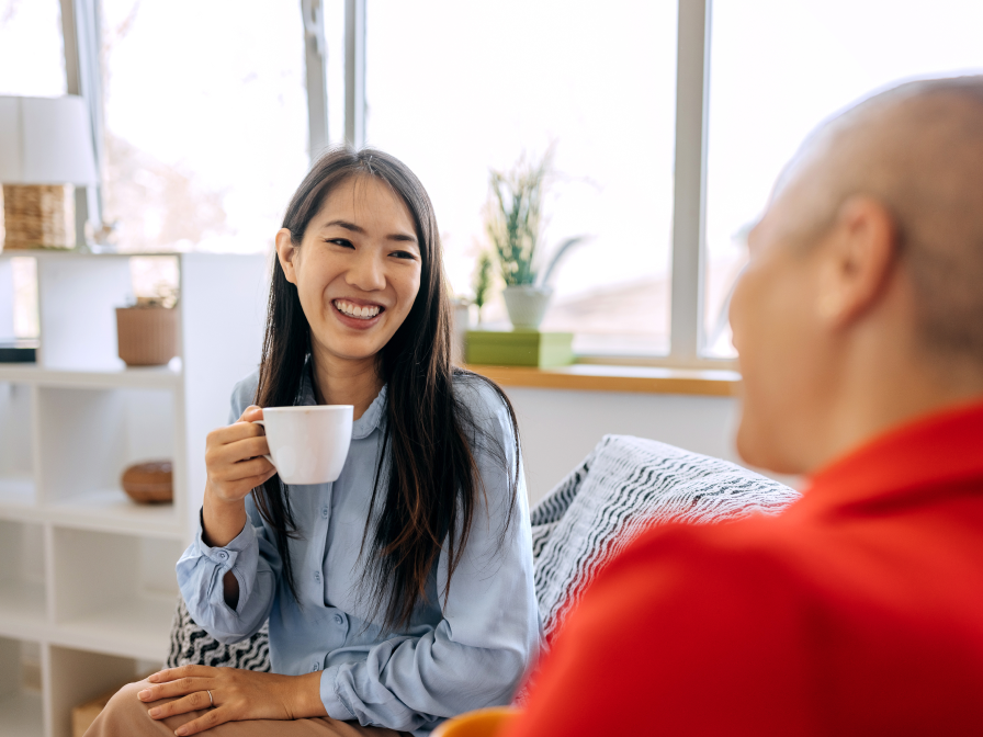 Woman and man sitting on couch smiling